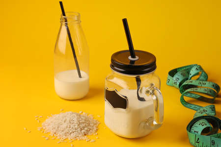 Organic vegan non-dairy buckwheat milk in a bottle and glass on a concrete kitchen table. Gluten and lactose free drink. Vertical positionの写真素材