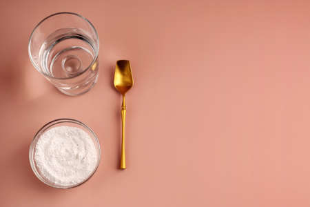 Healthy and anti-aging relaxation concept on pink background. Natural hydrolyzed cosmetic collagen supplement for rejuvenation. View from above. Copy space.の写真素材