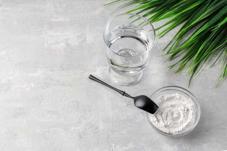 Natural hydrolyzed cosmetic collagen supplement for rejuvenation. Gold hourglass and powder spoon....