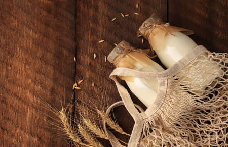 Diet drinks for breakfast. Vegetable vegan milk in mugs on a wooden background. Gluten and lactose...
