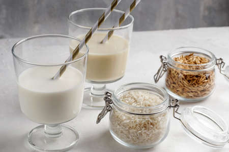 Natural breakfast. In glass glasses, gluten-free rice and buckwheat milk on a light background. Organic vegetarian drinks. Health conceptの写真素材