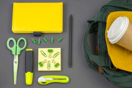 Office and school supplies, a backpack on a dark background. Back to school concept. Social distance. Stay safe. Top view.の写真素材