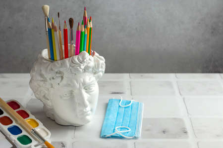 David's head plaster stand for office, creative and school supplies on a light background. Fashionable concept. Hygiene and protection against bacteria and viruses. Copy space.の写真素材