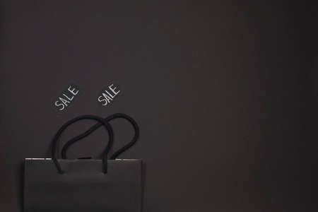 Shopping bag with text chalk on a dark background. Black Friday. Sale of purchases. Copy space.の写真素材