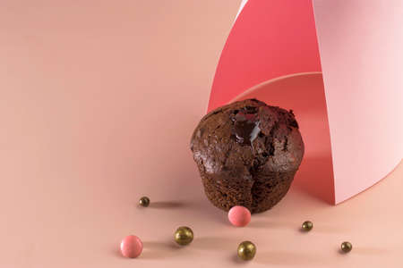 Holiday concept. Delicious homemade chocolate muffin with sweets on a pink background. Food geometric trend. Creative minimalist food design. Copy spaceの写真素材