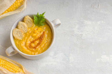 Healthy diet. Delicious creamy corn soup on a light background. Food for vegans and vegetarians....