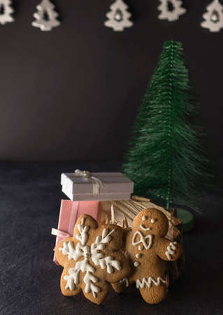 Christmas homemade gingerbread. Festive baked decorations, dessert on a dark background. New Year...