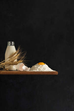 The concept of natural products for home cooking. Flour, milk, eggs, ingredients for freshly baked...