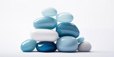 Shiny smooth glossy stones stacked in a small pileの素材