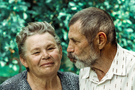 happy senior couple playful kissingの写真素材