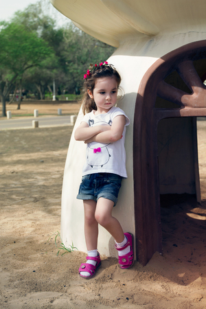 Serious litttle girl outdoor in denimの写真素材