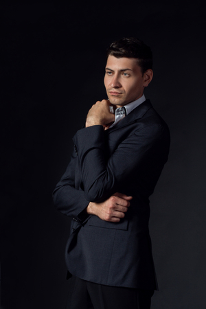 Handsome young man in suit on the black backgroundの写真素材