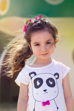 Serious litttle girl outdoor in denimの写真素材