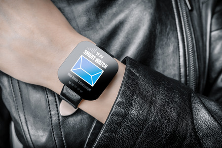 Smart watch. Isolated female body with black smart watch on hand.