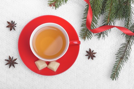 Red cup on a white knitted plaid.の写真素材