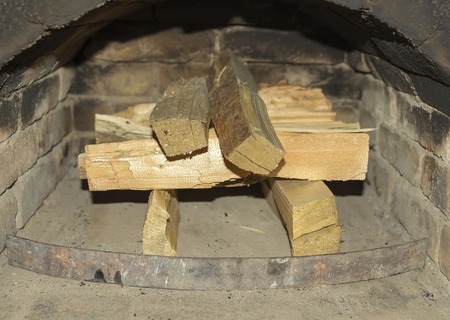 Dry firewood in the old a rural fireplace.