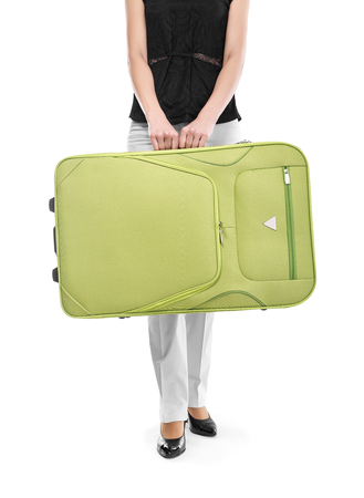 Woman holding a suitcase on white background.の写真素材
