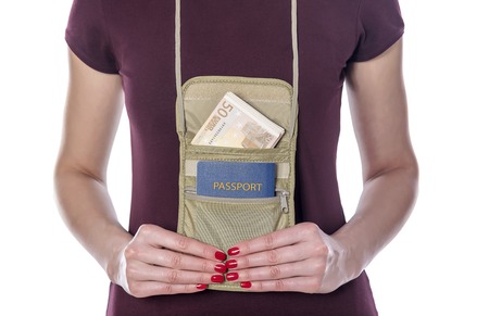 Woman with passport and money in the mobile bag on a white background.の写真素材