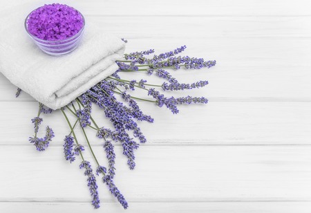 Sea salt is scattered on the white boards. Spa still life.の写真素材