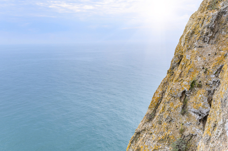 The rocky cliff on sea and sky background.の写真素材