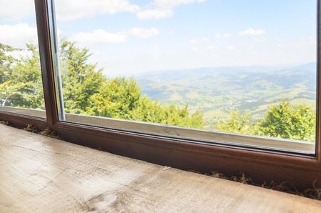 The old window with views of the beautiful mountains.の写真素材