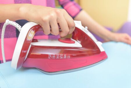 Ironing clothes on an ironing board. Close-up.の写真素材