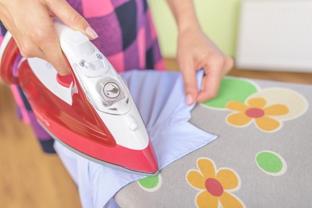 Ironing a shirt collar on the ironing board.の写真素材