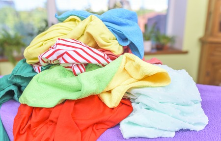 A pile of clothes on the ironing board.の写真素材