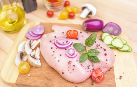 Chicken fillet with spices on a cutting board. Close-up.の写真素材