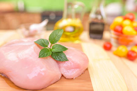 Chicken fillet with spices on a cutting board. Close-up.の写真素材