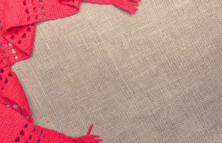 A red scarf on the background of burlap.の写真素材