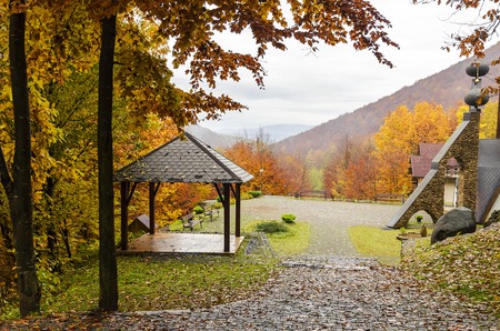 A wooden a gazebo in the mountains in autumn.の写真素材