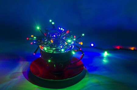 Christmas lights in the cup on a dark background.の写真素材