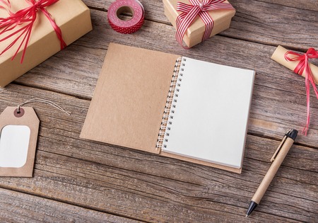 Notebook and Christmas gifts on wooden boards.の写真素材