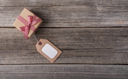Greeting card and a gift on a wooden background. Space for your text.