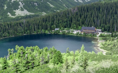 House by the lake in the mountains. View from above.