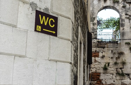 WC plaque on the wall of a house in the tourist town.の写真素材