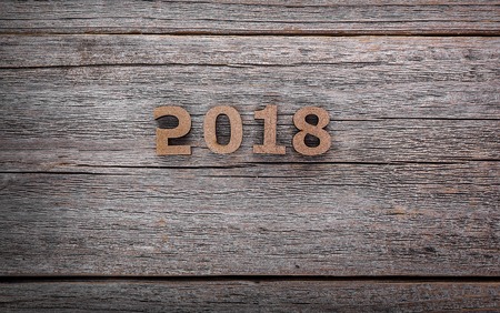 Figures 2018 on a wooden background close-up.