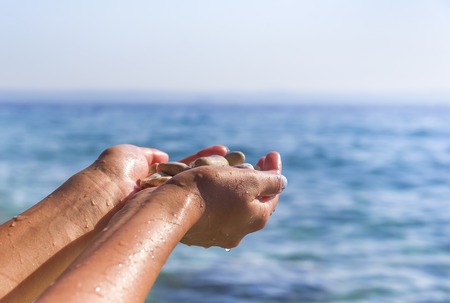 Sea pebbles in the hand.