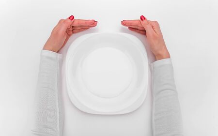 Female hands and an empty plate.の写真素材
