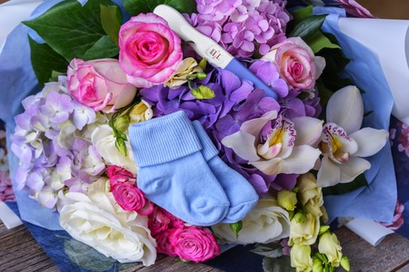 Pregnancy test and flower bouquet.の写真素材