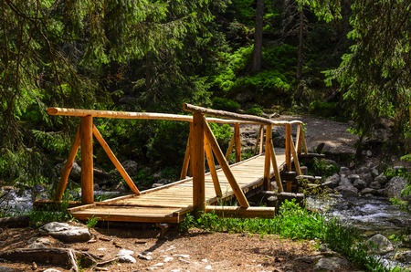 Wooden bridge over a mountain river. Close-up.の写真素材