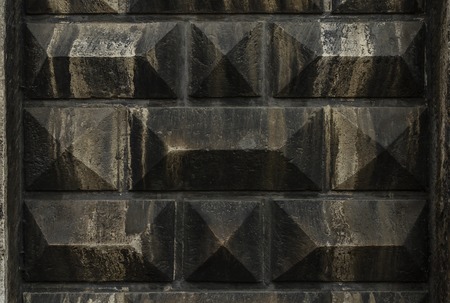 Reliefs on the concrete wall. In dark colors.の写真素材