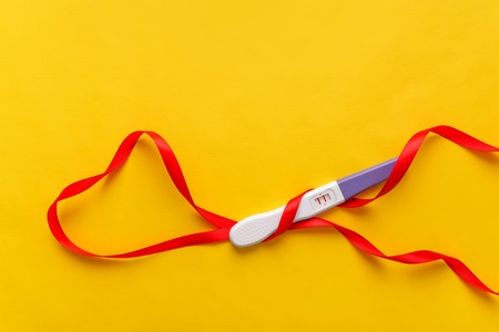 Pregnancy test on a yellow background. The result is positive. Two strips.の写真素材