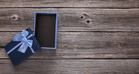 Open gift box on the background of wooden boards.の写真素材