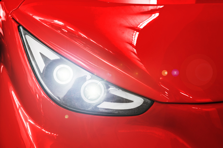 Headlight of a red sports car.の写真素材