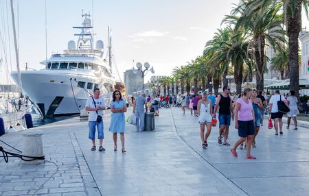 Tourists walking around the city on a summer day in Trogir, Croatia.