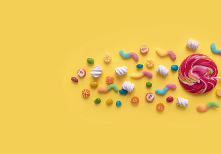 Scattering of sweets on a yellow background.の写真素材