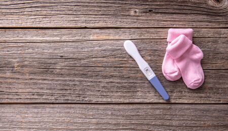 Pregnancy test as a still life on a wooden background.の写真素材