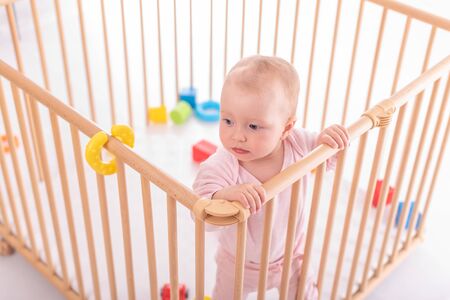 Baby girl at childrens playpen.